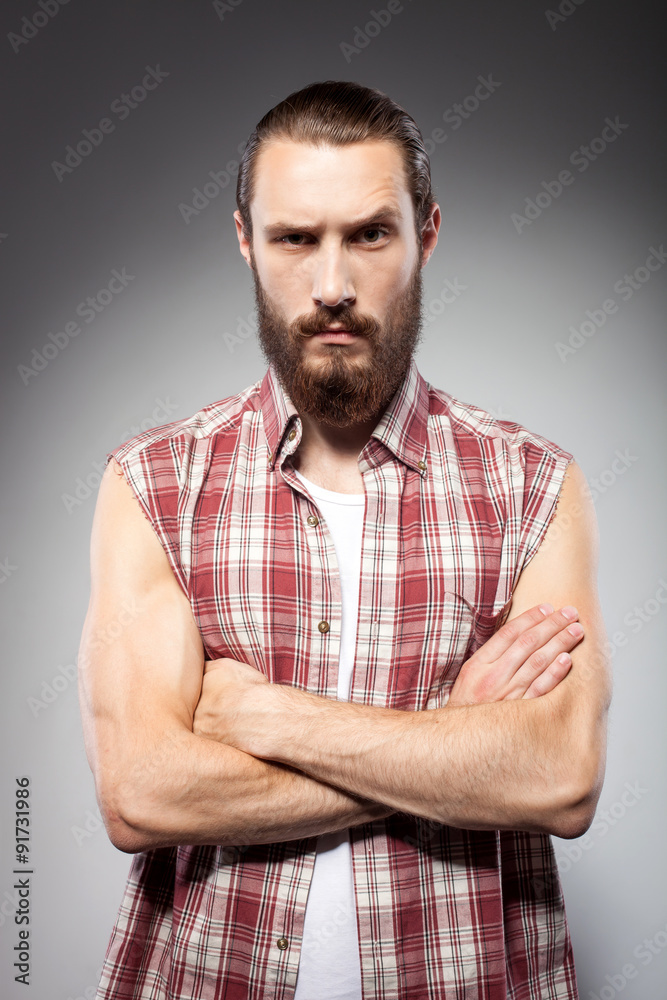 Attractive young man with beard is serious Attractive young man with beard is serious