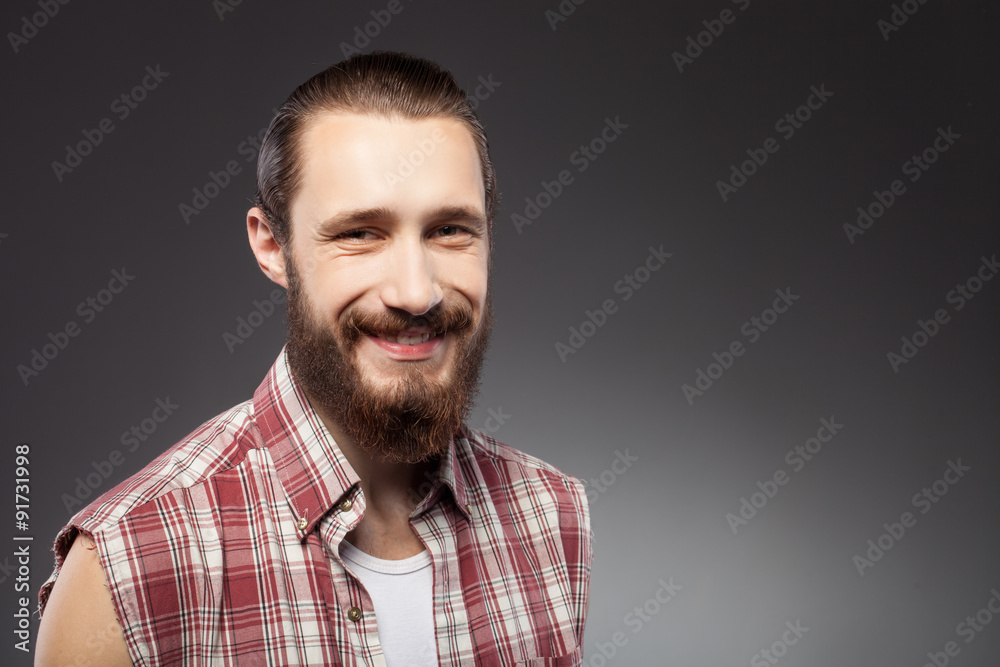 Obraz premium Cheerful young bearded guy is expressing positive emotions