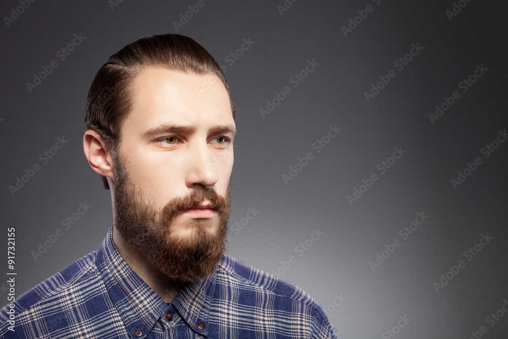 Fototapeta premium Attractive young man with beard is pensive and sad