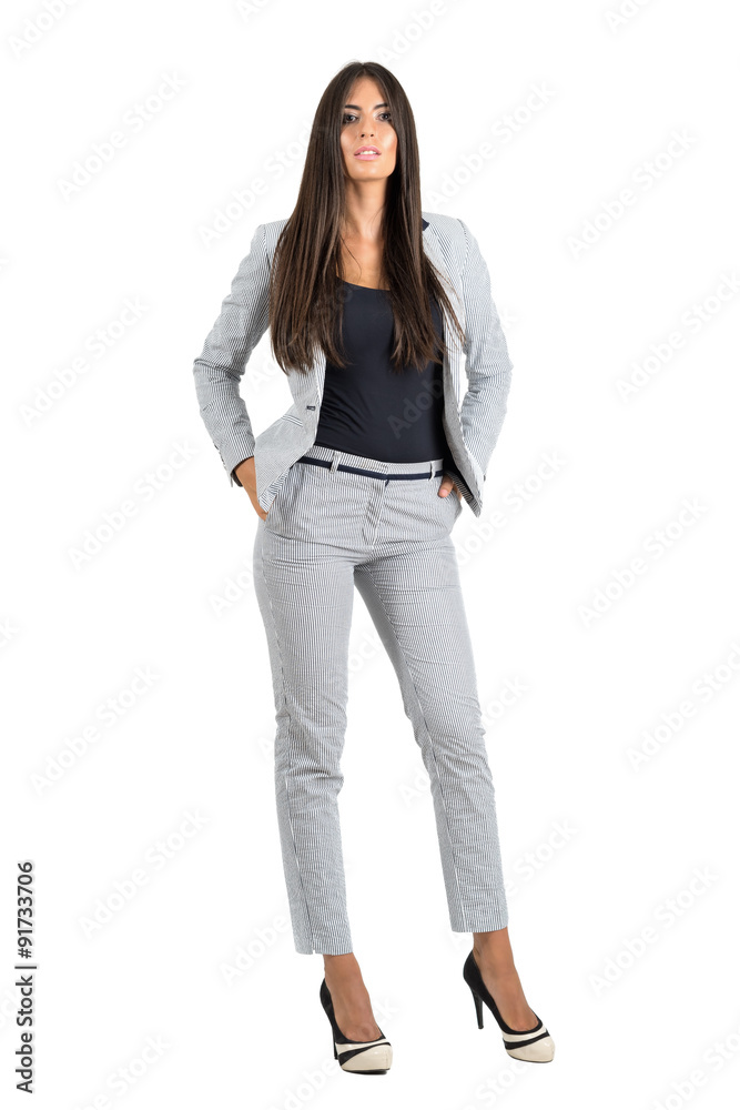 Sexy confident bossy businesswoman with hands in pockets looking at camera Sexy confident bossy businesswoman with hands in pockets looking at camera