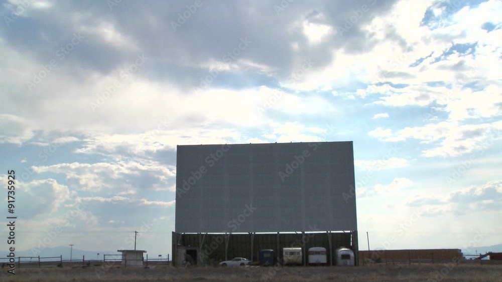 A time lapse shot of clouds passing over an abandoned drive in theater screen. A time lapse shot of clouds passing over an abandoned drive in theater screen.