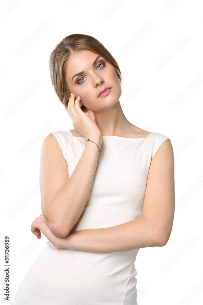 Studio portrait of a beautiful young woman standing against a Studio portrait of a beautiful young woman standing against a