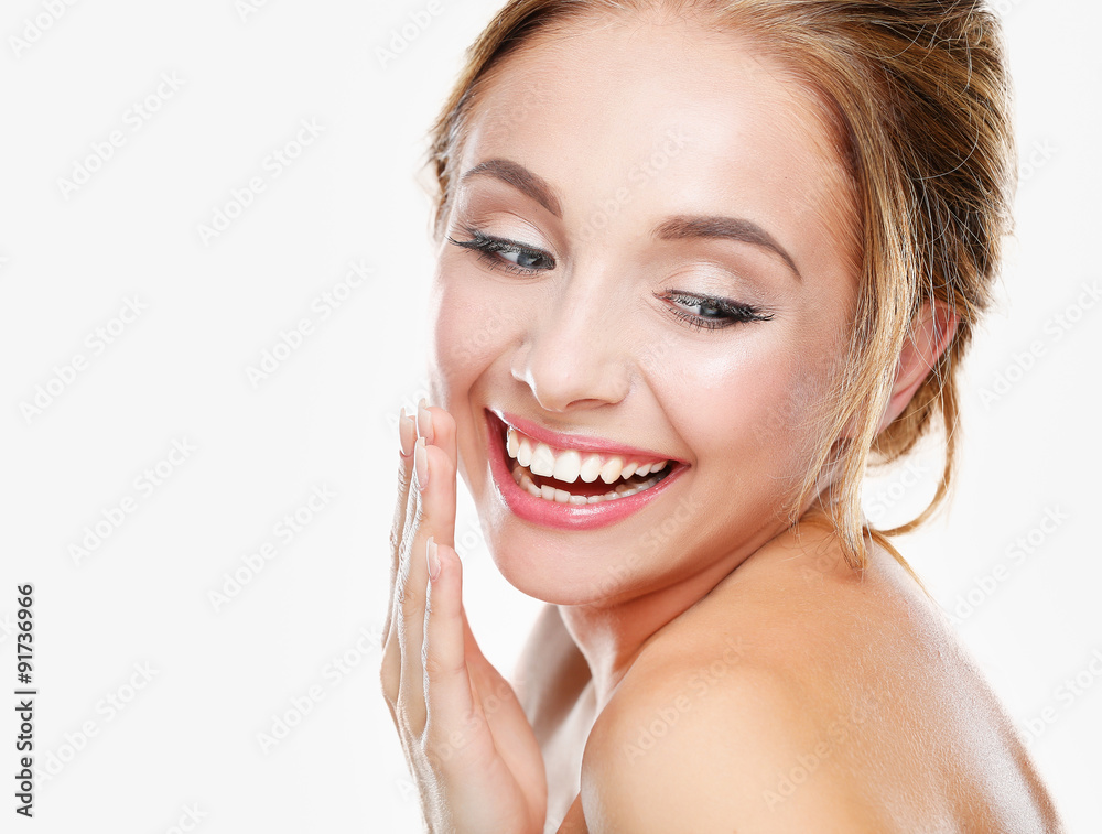 Studio shot of a beautiful young woman with perfect skin against Studio shot of a beautiful young woman with perfect skin against