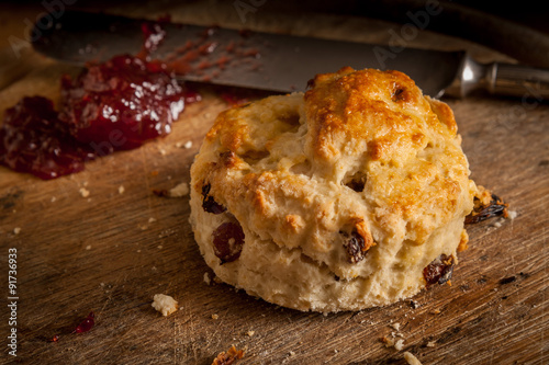 Homemade scone with strawberry jam ready to eat. photo