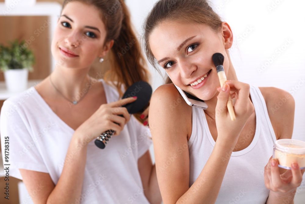 Two young women pampering themselves at a sleepover. Two young women pampering themselves at a sleepover.