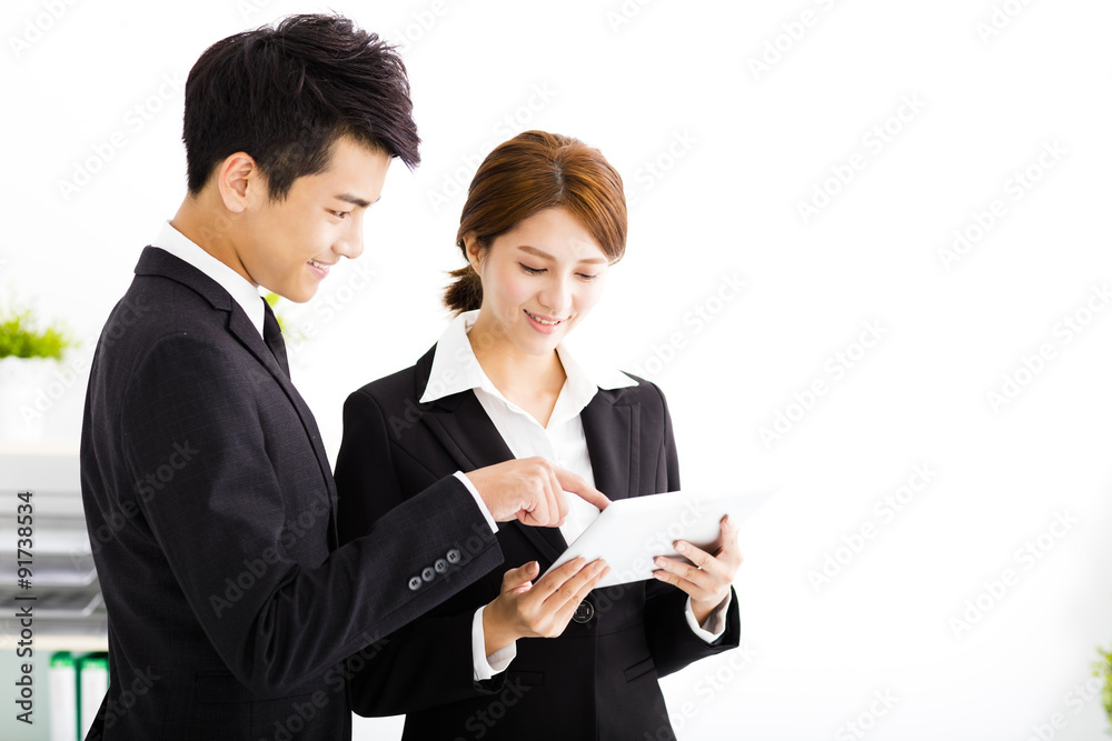 business partners looking at business document in tablet business partners looking at business document in tablet