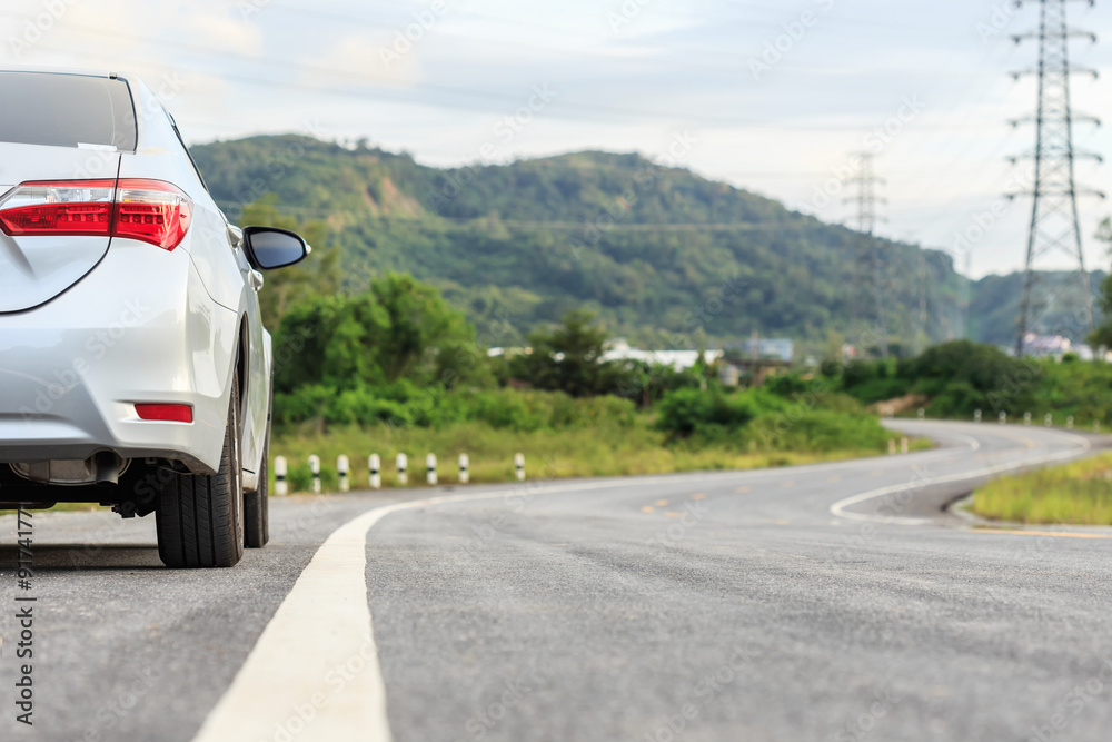 New silver car parking on the asphalt road