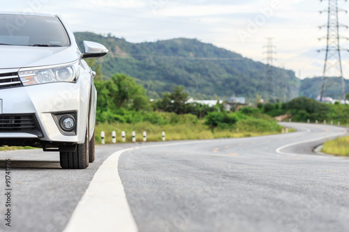 New silver car parking on the asphalt road © SKT Studio