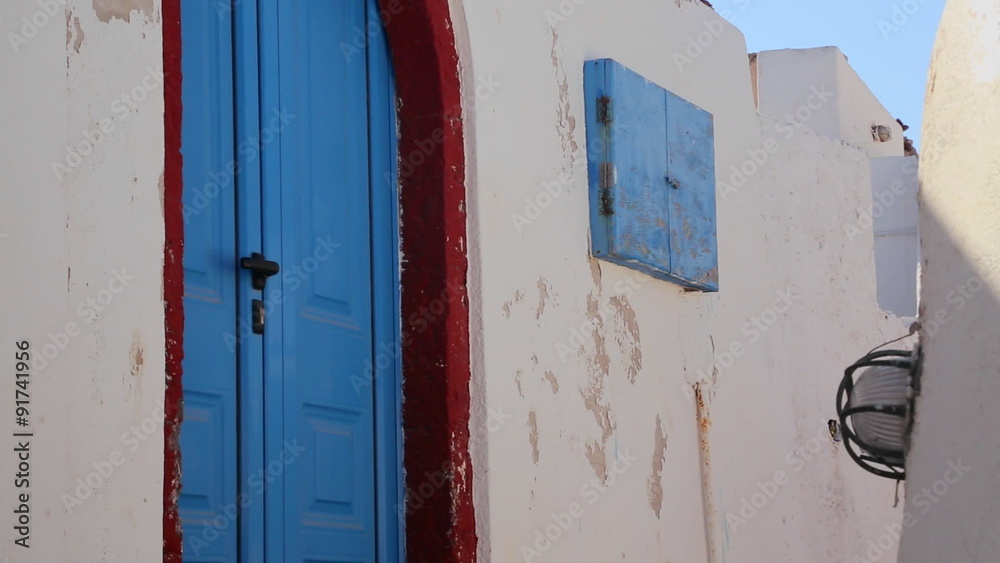 Beautiful whitewashed walls and blue doors on the island of Santorini in Greece. Beautiful whitewashed walls and blue doors on the island of Santorini in Greece.