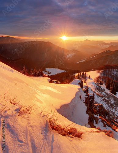 Majestic sunset in the winter mountains landscape. Dramatic sky