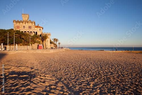 Sunset at sandy Tamariz beach by the Atlantic Ocean in resort town of Estoril, municipality of Cascais, Portugal.