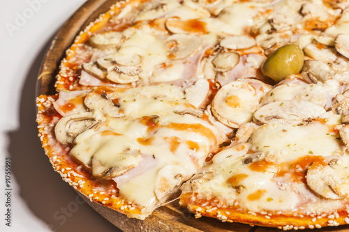 Tasty pizza on wooden board