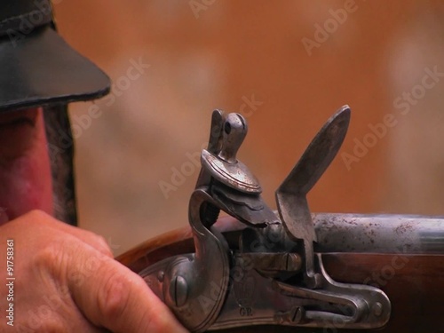 A soldier fires a musket at a reenactment of the Battle of The Alamo.