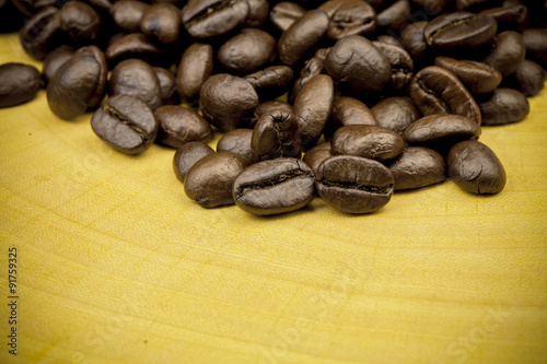 Roasted Coffee Beans background texture on wooden background.