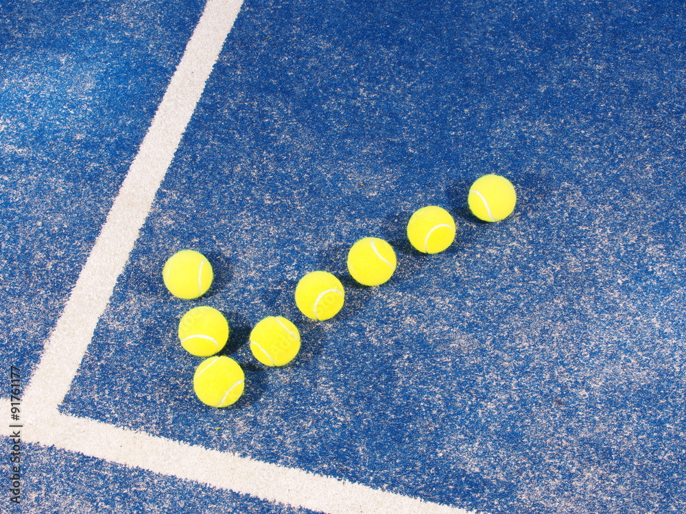Tick symbol of Tennis balls a pristine blue artificial grass court, Melbourne, Australia 2015