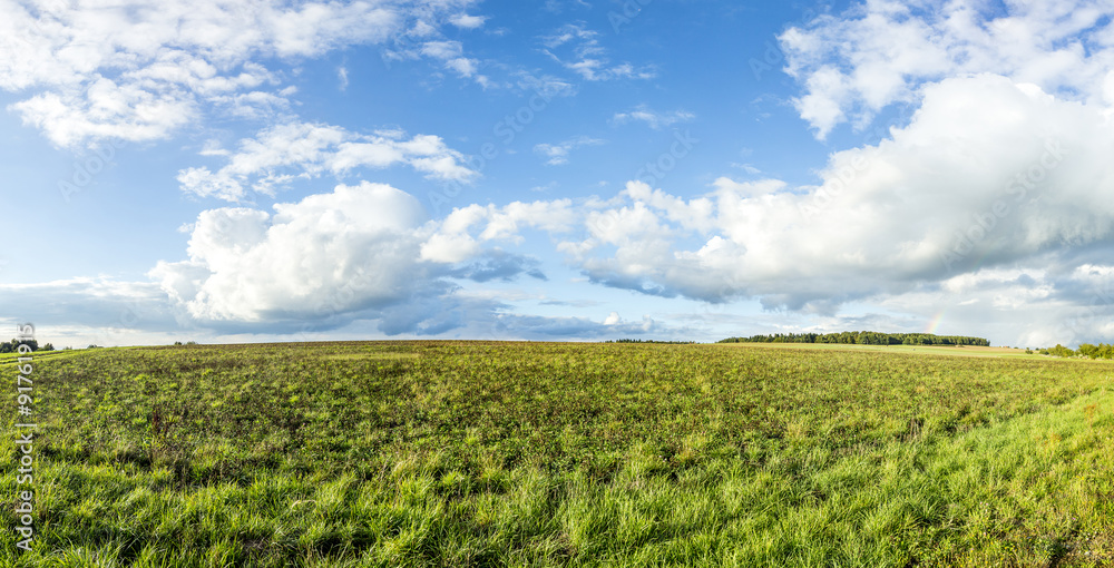 rural landscape with fields and clouds in bright sunset