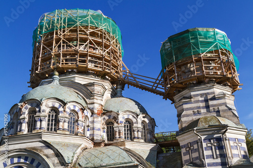 Two domes of the Russian orthodox church in scaffolding round shape, against the blue sky in Švenčiony, city located 84 kilometers (52 mi) north of Vilnius in Lithuania.