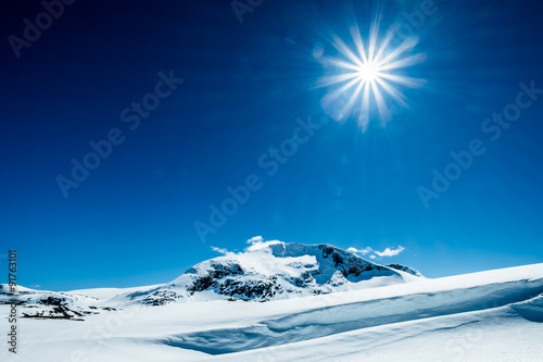 Sun and snowy mountain.