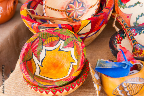 colorfully painted wooden bowls in market