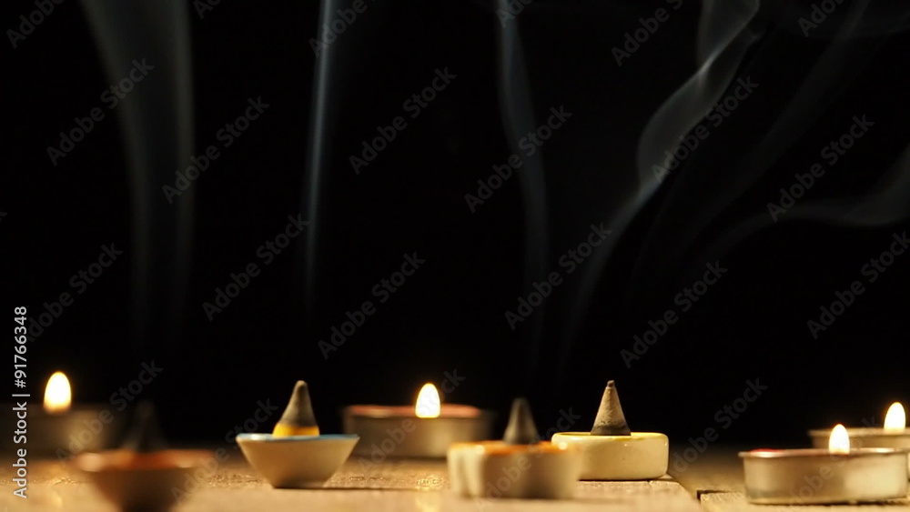 Incense cone or gum benjamin with abstract smoke, black background.
