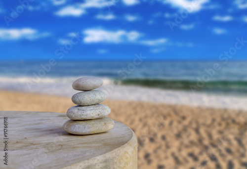 Balanced several Zen stones on blurred beautiful the beach backg