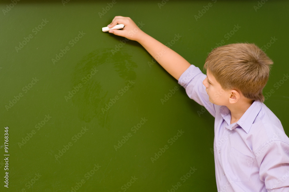 student writing on the chalkboard student writing on the chalkboard