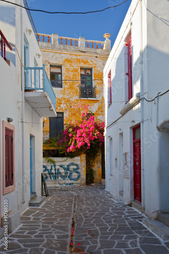 Street with traditional architecture in the old part of Parikia which is the capital and main port of Paros island in Greece.