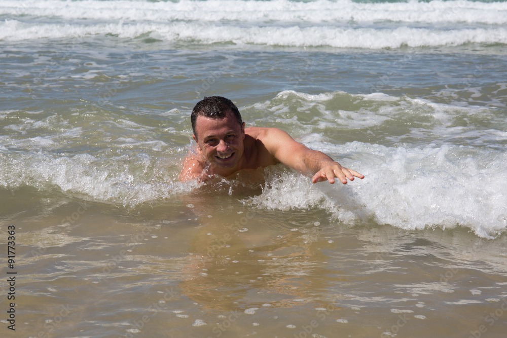 Man having fun at the beach during summertime Man having fun at the beach during summertime