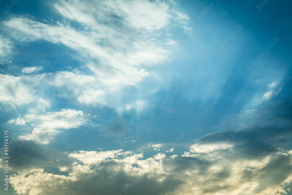 light of sunbeam on blue sky background with clouds