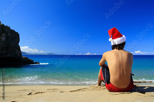  Santa Claus from the back on beach of ocean