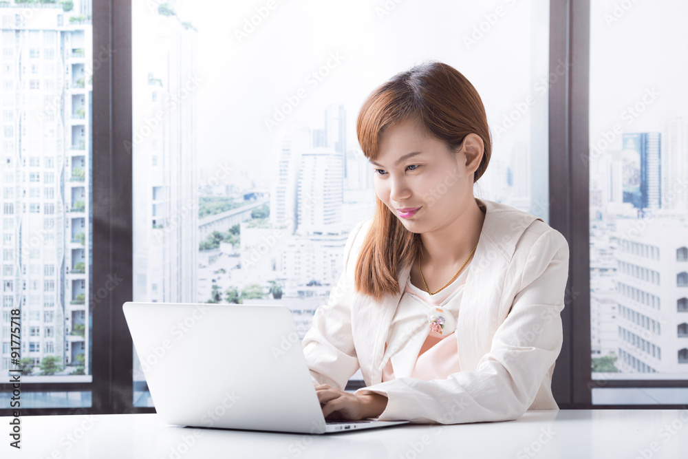 Business woman working on laptop computer at office Business woman working on laptop computer at office