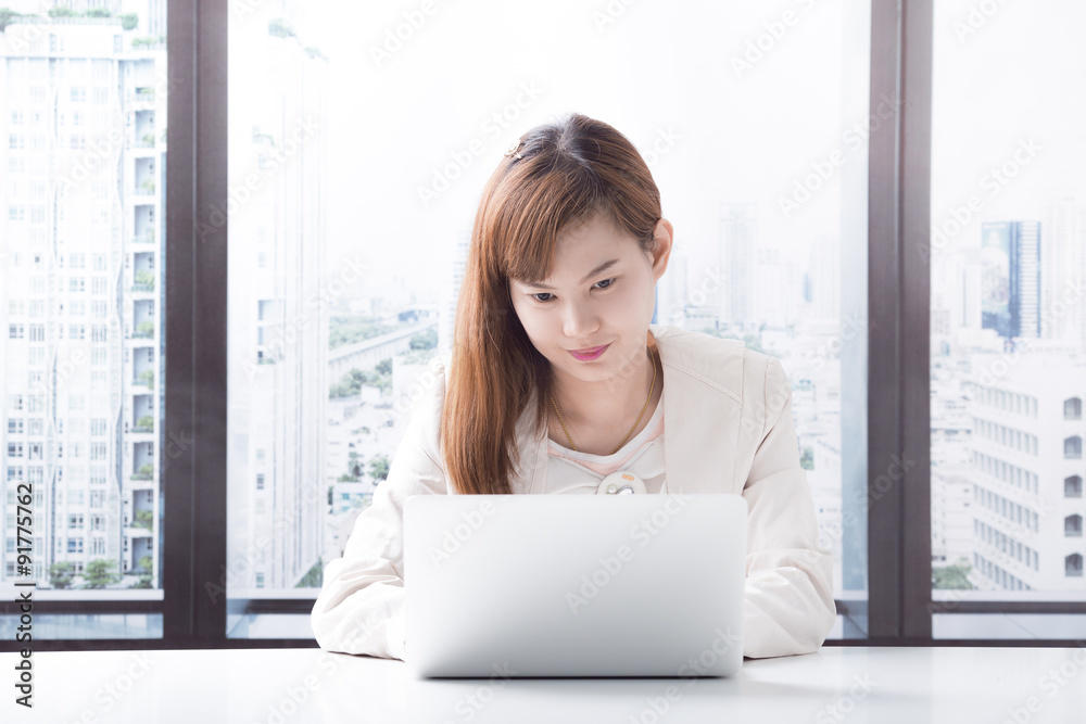 Business woman working on laptop computer at office Business woman working on laptop computer at office