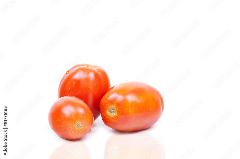 Ripe tomatoes closeup on white background Ripe tomatoes closeup on white background