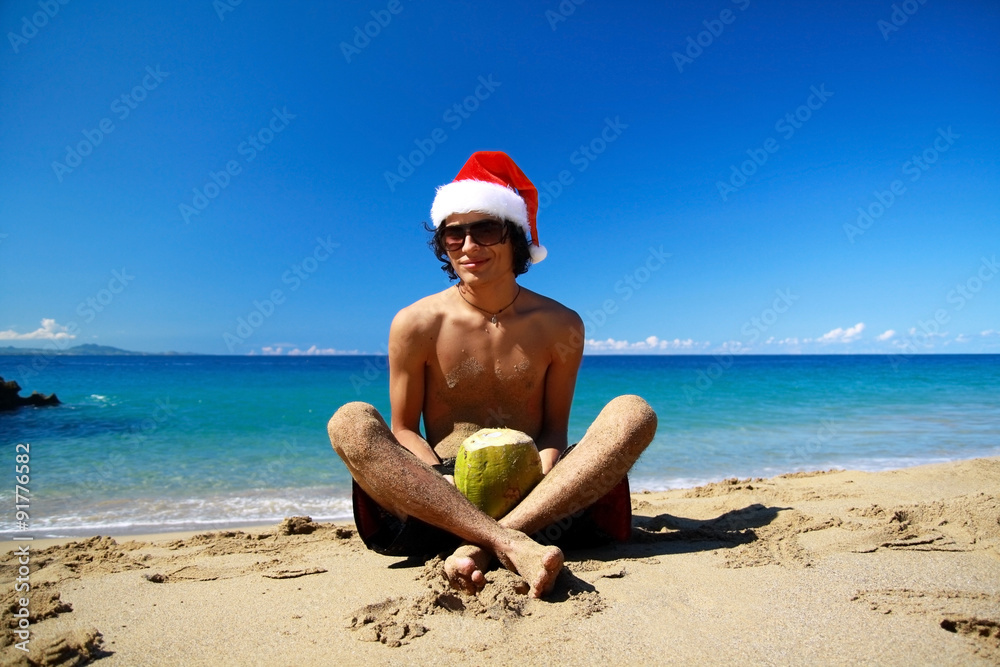 Man in santa claus hat on a beach Man in santa claus hat on a beach