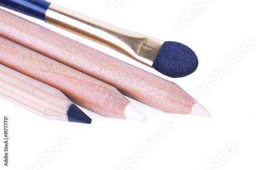 Make up pencils with applicator on white photo