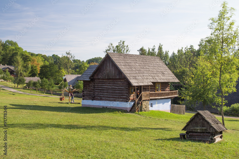 traditional wooden farm house on meadow