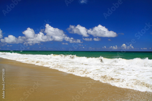 Tropical sandy shore with white sand and turquoise water photo
