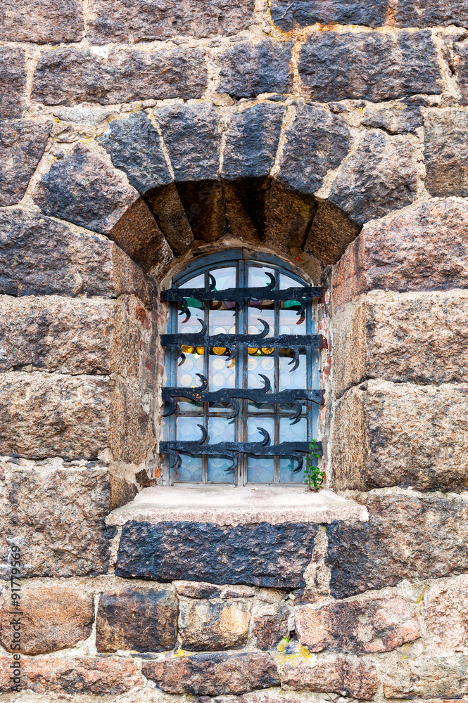 Old window at the medieval castle in Vyborg, Russia