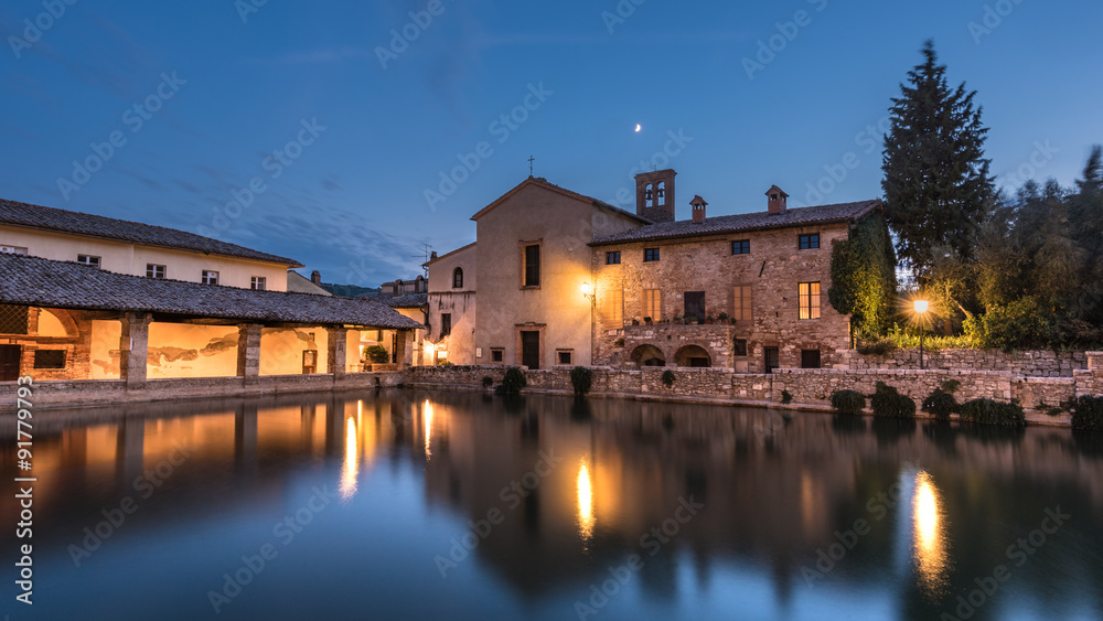 View on thermal bath in the medieval Tuscan town at dusk.