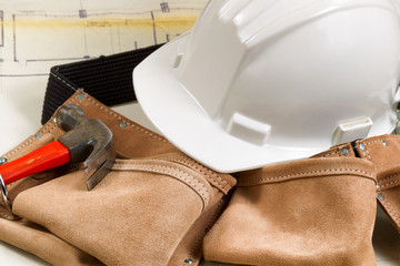 Construction contractor tools with blue print drawings in backgr