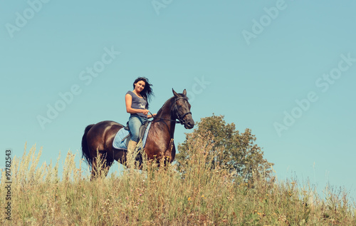 Portrait of a beautiful young woman riding a horse. © pavelkriuchkov