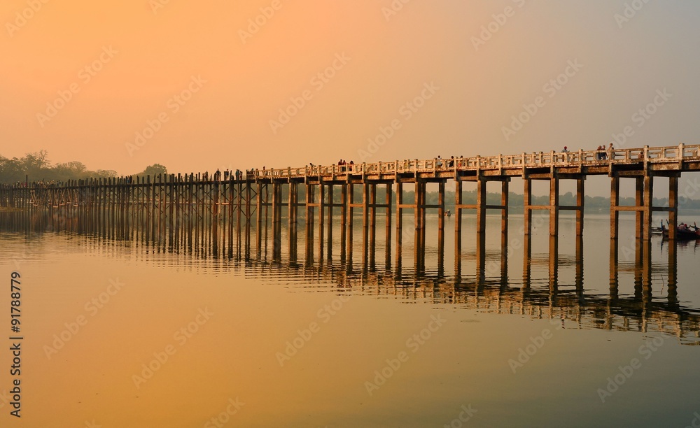 Amarapura, Myanmar - 14 March 2015: People walking on the wooden bridge of U Bein on river Ayeyarwad, Myanmar