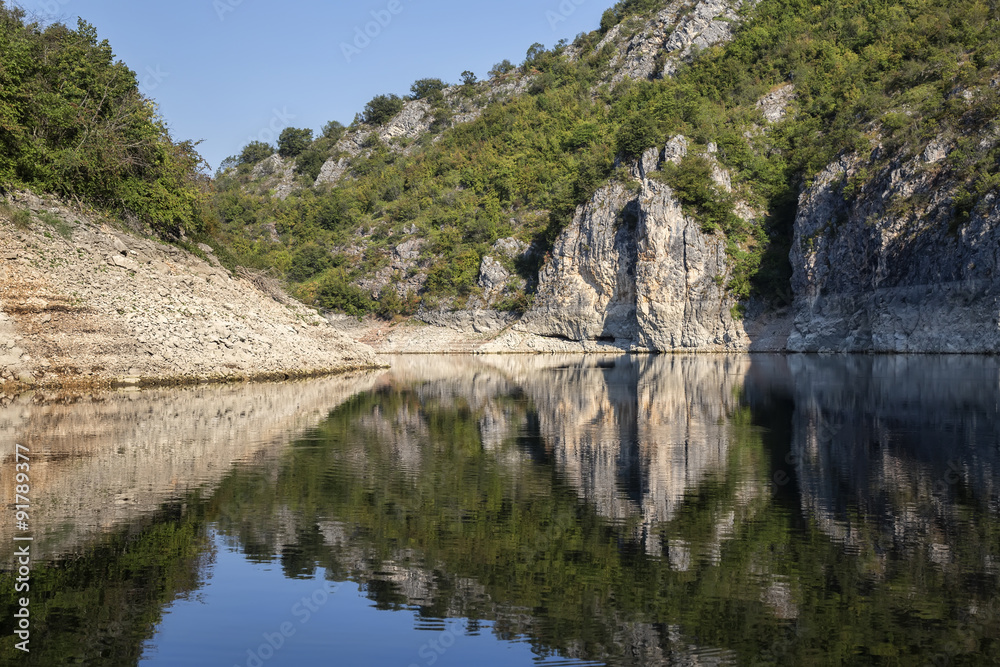 Reflections of cliff walls and trees