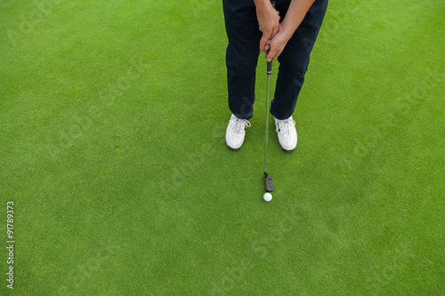 Golf player at the putting green photo