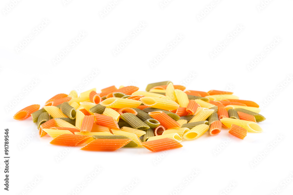 Raw colored pasta isolated on white background