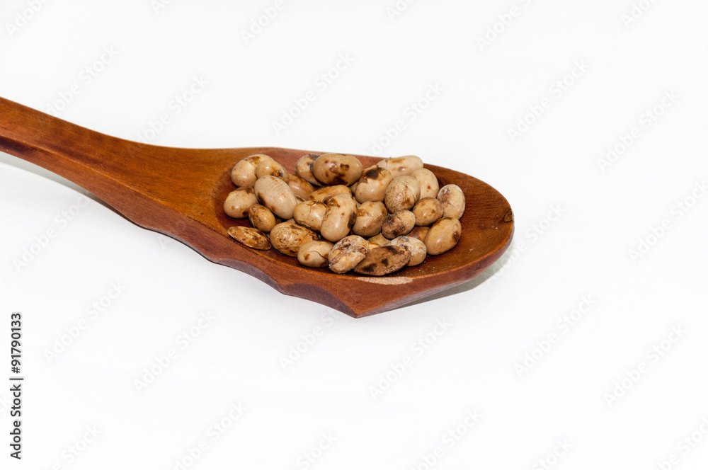 Soy beans on the retro wooden spoon Soy beans on the retro wooden spoon
