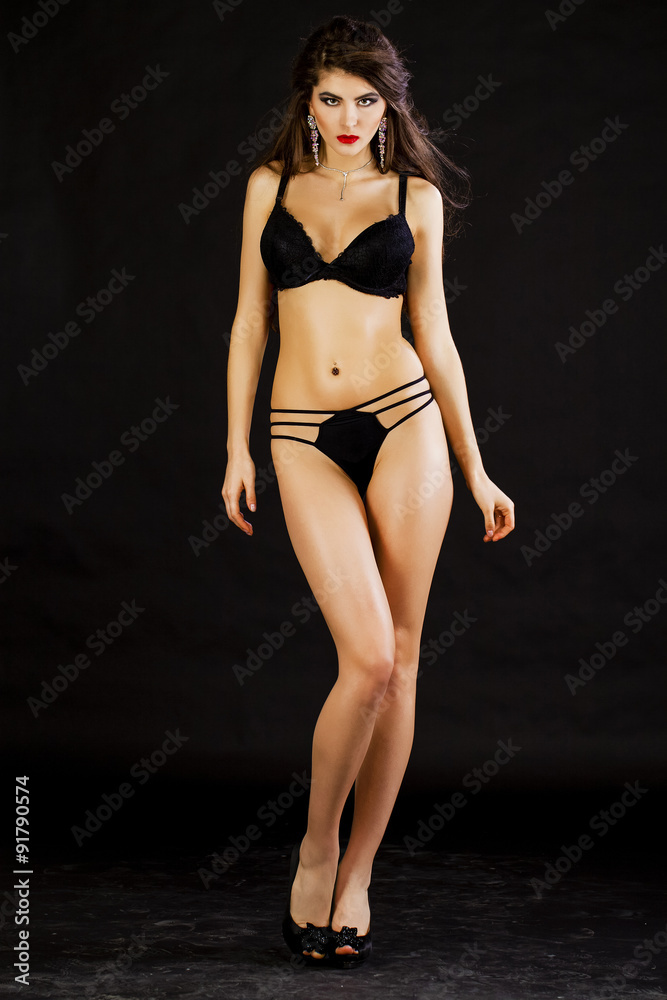 Fashion portrait of a professional model in black sexy underwear