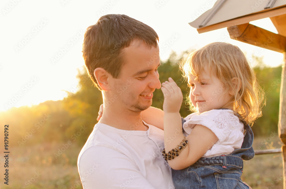 Fototapeta premium Dad and daughter in sunlight