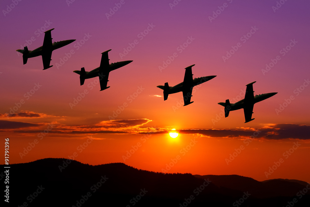 Fighter jets in the sky at sunset