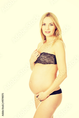 Smiling pregnant woman in lingerie © Piotr Marcinski